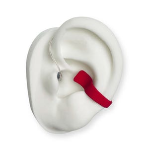 May include: A white ear model with a red earplug and a thin, silver wire. The earplug is inserted into the ear canal. The model is set against a white background.