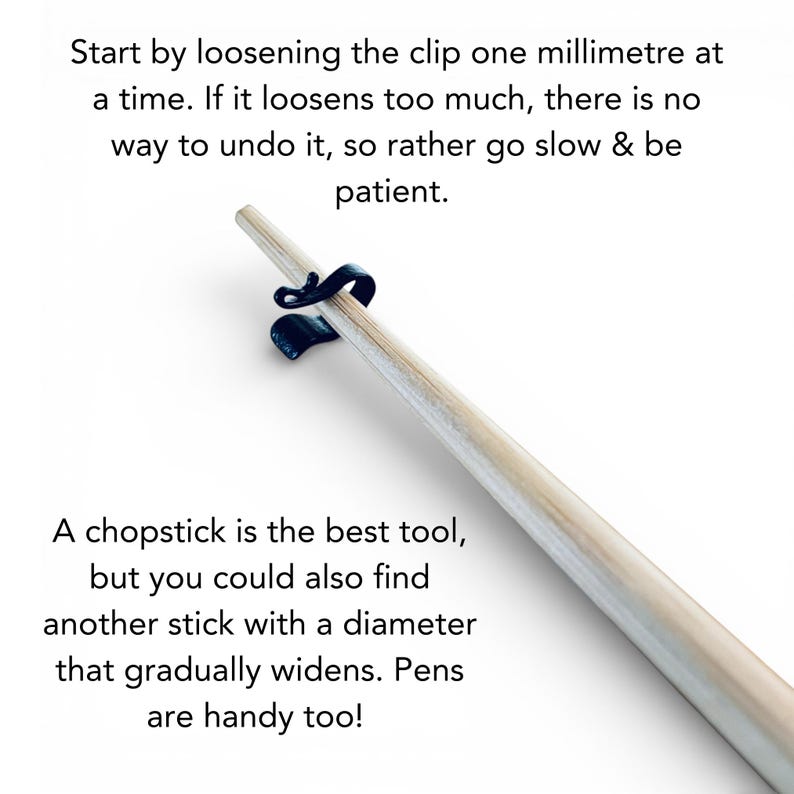 May include: A light-colored chopstick is held by a black clip. Text on the image advises to loosen the clip slowly. Additional text suggests using a chopstick or similar tool. The background is white.