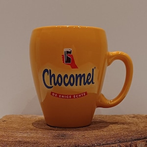 Chocomel, one mug or set of two yellow &#39;classic&#39; mugs from the Dutch chocolate milk brand, logo of the hand with the glass of chocolate milk
