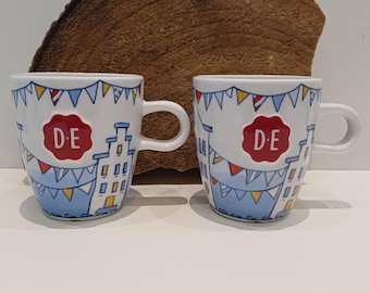 Douwe Egberts, set of two small coffee mugs, nice image of canal houses, embossed with the Douwe Egberts brand