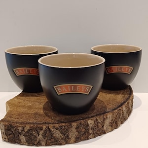 Baileys, set of three &#39;handleless&#39; stylish black ceramic cups, mugs with Baileys logo on one side, Baileys colourful interior