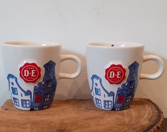 Douwe Egberts, single mug or set of two or four mugs, images of canal houses, embossed Douwe Egberts brand (seal)