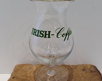 A beautiful Irish coffee glass on a foot and with a 'belly', with green letters stating 'Irish - Coffee' and a gilded rim, 70's