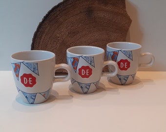Douwe Egberts, set of two or three small coffee mugs, with an image of cheerful flags, with the Douwe Egberts brand embossed