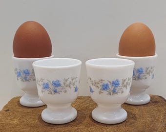 Arcopal - France, set of four egg cups, milk glass, design called Romantique; decoration of small blue flowers, 70s