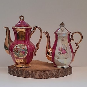 Two nice mocha coffee pots, the first pink with white and mother-of-pearl and gold accents, the second pink with gold accents, 1970s