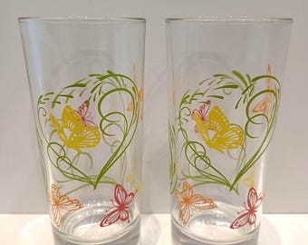Set of two long drink glasses, images of fluttering yellow, red, and orange butterflies in green, thick base, 1990s, marked Italy