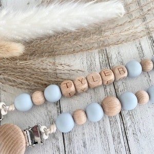May include: A light blue and natural wood baby teether with the name 'Tyler' spelled out in wooden beads. The teether is attached to a clip for easy attachment to clothing. Personalized Pacifier Clip / Custom Baby Name / Personalized Baby Gift / Baby Shower gift /last minute gift / Newborn gift / Boho baby