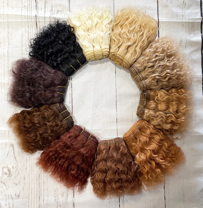 May include: A set of ten hair wefts in various shades of brown, blonde, and black. The wefts are arranged in a circle and are all curly.