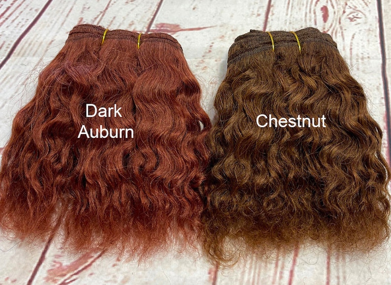 May include: Two bundles of wavy human hair extensions, one in dark auburn and one in chestnut brown.