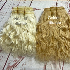May include: Two bundles of wavy human hair extensions, one labeled "Natural Blonde" and the other labeled "Golden Blonde".