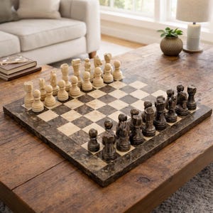May include: A chess set with a marble board and carved chess pieces. The board features a checkered pattern in shades of beige and brown. The chess pieces are in two colors: light beige and dark brown.
