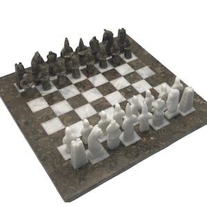 May include: A marble chess set with black and white pieces on a brown and white marble board.