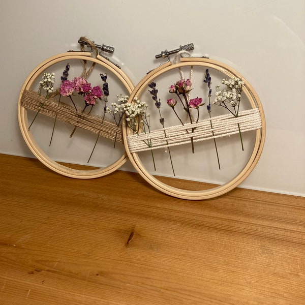 Dried flower wreath in embroidery frame decorated with roses, lavender and veil herb