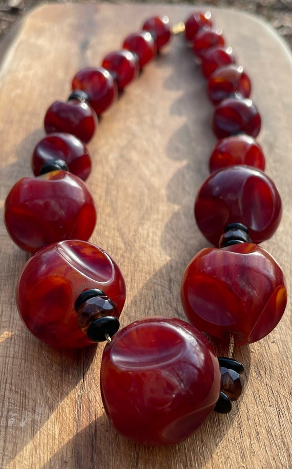 Sold at Auction: Antique Chinese carved cherry amber figural bead necklace  strand with 18 unique laughing heads, one bead with carved signature on  fruit form bead, and one full figure Buddha bead.