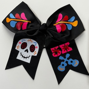 May include: Black bow with a sugar skull and "5K" with crossed guitars in pink, blue, and orange on a black background.