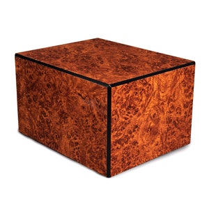 May include: A rectangular wooden box with a dark brown wood grain pattern and a black trim around the edges.