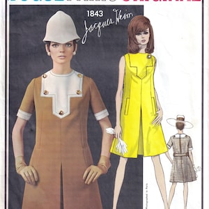 May include: Vintage Vogue Paris Original sewing pattern 1843 by Jacques Heim. The pattern shows illustrations of women's dresses in brown and yellow. The text "Vogue Paris Original" and designer's name are visible.