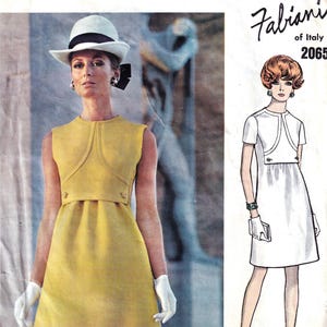 May include: Vintage Vogue Couturier Design sewing pattern featuring a woman in a yellow dress, white gloves, and a hat. The pattern includes a Fabiani of Italy design, number 2065, with a sketch of a white dress.
