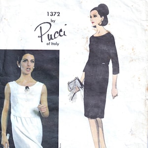 May include: Vintage Vogue Couturier Design pattern featuring a black dress illustration by Pucci of Italy. The pattern number is 1372. The image includes a drawing of a woman in a black dress and another in a white dress.