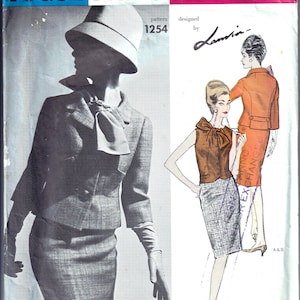 May include: A Vogue Paris Original sewing pattern envelope 1254 designed by Lanvin. The front features a black and white photograph of a suit with a hat and gloves, alongside a colour illustration of a sleeveless top and a skirt or jacket.