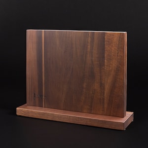 May include: A dark brown wooden magnetic knife holder with a stand. The holder has a vertical grain pattern and the text "FRANKLIN" is engraved on the front.