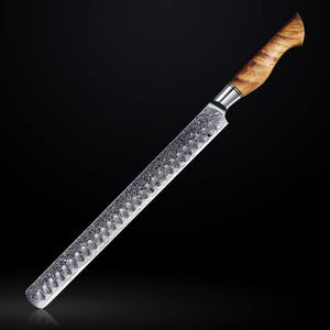 May include: A long, silver bread knife with a wooden handle. The blade has a decorative pattern and is very sharp.