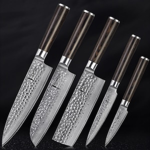 May include: Set of five kitchen knives with black wood handles and a hammered finish. The blades are stamped with the word "SENKEN".