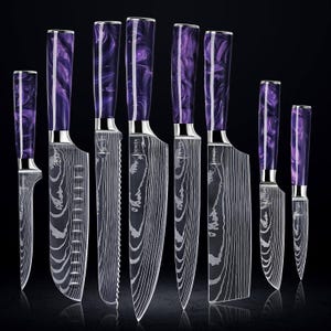 May include: Set of eight kitchen knives with purple and silver handles. The knives have a Damascus steel blade pattern and are arranged in order of size.