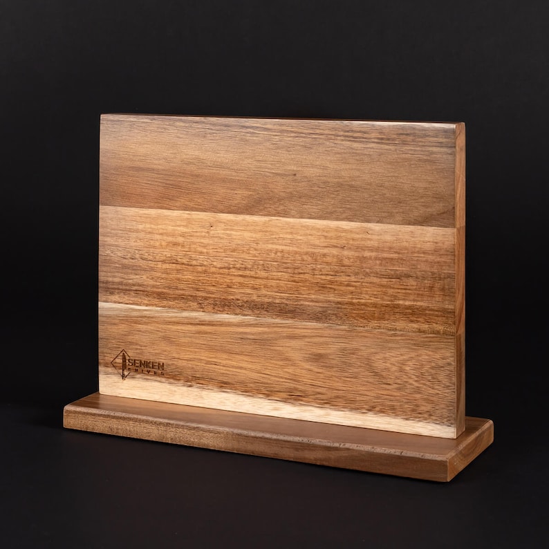 May include: A wooden magnetic knife holder with a stand. The holder has a natural wood finish and the brand name "SENKEN" is engraved on the front.