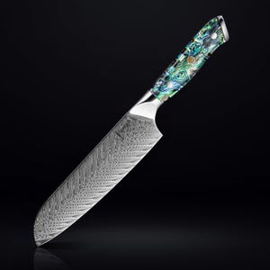 May include: A silver chef's knife with a patterned blade and a blue, green, and white mother-of-pearl handle.