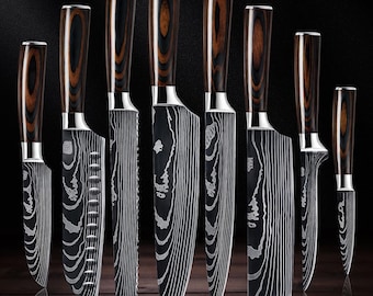 May include: A set of eight kitchen knives with dark wood-grain handles and silver bolsters. The blades feature a black finish with a prominent white wavy pattern, including various blade shapes like chef, serrated, and paring knives.