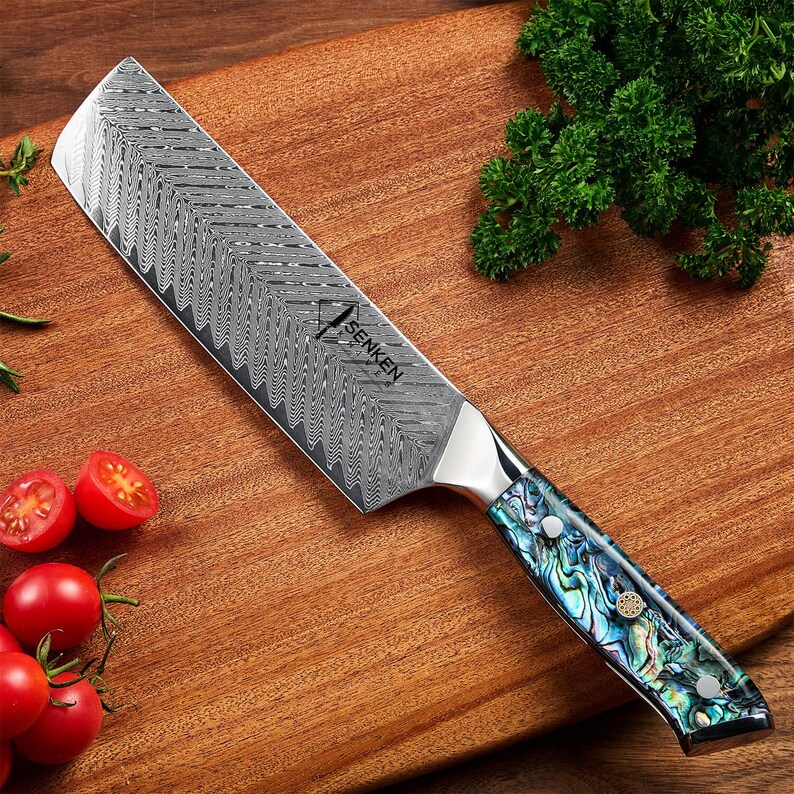 Umi Damascus Steel Japanese Cleaver Abalone Shell VG-10 67-Layer Nakiri Knife on Kitchen Countertop