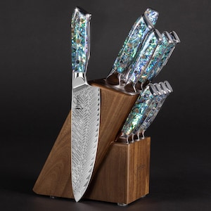 May include: A set of 8 kitchen knives with a wood block holder. The knives have a silver blade and a blue and green iridescent handle. The block is made of dark wood.