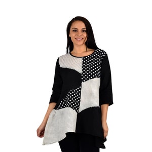 May include: Black and white patterned tunic top with a geometric design. The top has a scoop neck and three-quarter sleeves.