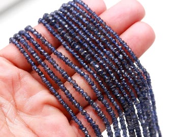 May include: A strand of blue gemstone beads, likely kyanite, with a faceted, slightly irregular shape. The beads are strung on a clear thread and are approximately 2mm in diameter.