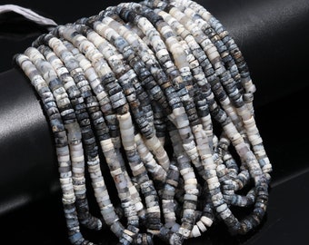 May include: A strand of white and gray opal beads. The beads are small and round, and they have a speckled appearance. The beads are strung on a clear thread.