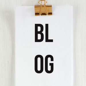 May include: A white sheet of paper with the words "BL OG" written in black, held by a gold paper clip. The text below reads "THE ULTIMATE GUIDE TO STARTING A SUCCESSFUL BLOG: FROM IDEA TO EXECUTION."