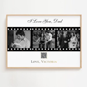 May include: A rectangular wall print in a light wood frame featuring the text I Love You, Dad at the top and Love, Victoria at the bottom. The centre displays three black and white film strip frames with photos, plus a small QR code square.