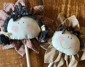 Large, rustic-style fabric flowers with a face and hairstyle
