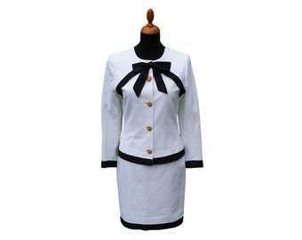 White two piece costume cotton Piqué with black silk taffeta border