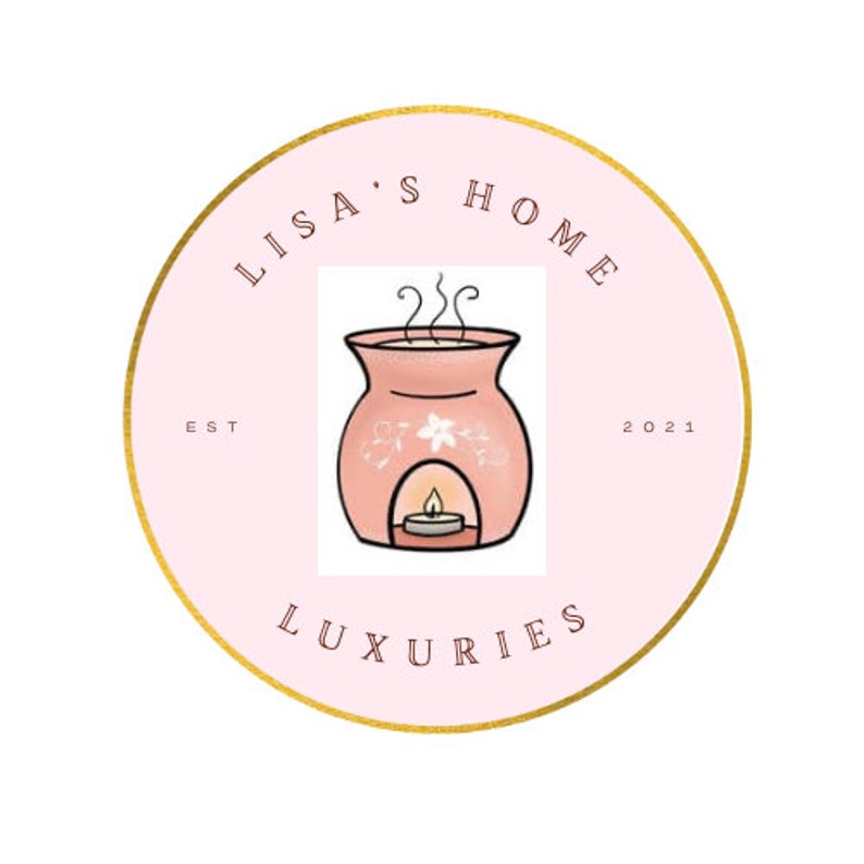 May include: A pink circle with a gold outline and the text "Lisa's Home Est 2021 Luxuries" around the edge. In the center is a cartoon image of a pink oil diffuser with a white flower design and a lit candle inside.