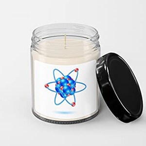 May include: A clear glass jar candle with a white label featuring a blue and red atom illustration. The jar has a black lid.