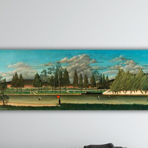 May include: A rectangular painting depicts a park scene with a river, trees, and a cloudy sky. The artwork features a green landscape with figures, a red object, and a building in the background. The painting is mounted on a white wall.