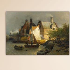 May include: A framed landscape painting depicts a European town with a river, boats, and buildings. A sailboat with a white sail is in the center. The buildings have red tile roofs. The painting has a muted color palette with a cloudy sky.