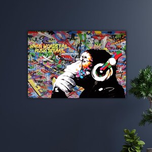 May include: A colorful graffiti art print featuring a black silhouette of a person wearing headphones. The artwork includes the text "WHEN WORDS FAIL MUSIC SPEAKS" and "SHAKESPEARE" against a vibrant background of graffiti.