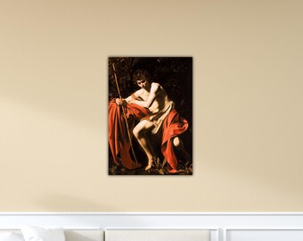 May include: A framed print of a classical painting. The artwork shows a seated figure draped in red fabric, holding a staff. The background is dark, with hints of foliage. The figure is partially nude, with a contemplative expression.