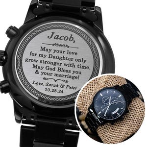 May include: Black chronograph watch with a personalized engraved message on the back. The message reads "Jacob, May your love for my Daughter only grow stronger with time. May God Bless you & your marriage! Love, Sarah & Peter 10.28.24"