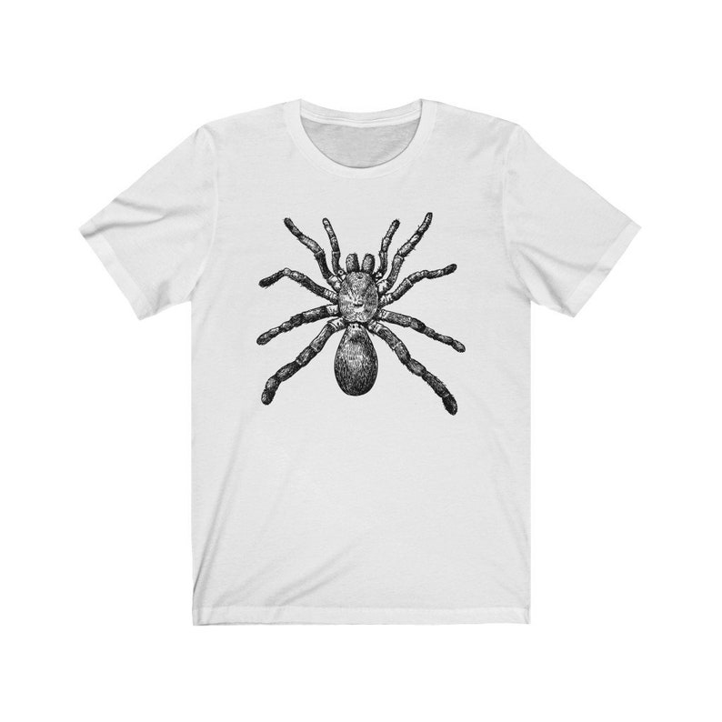 May include: A white t-shirt with a black and white illustration of a spider on the front.