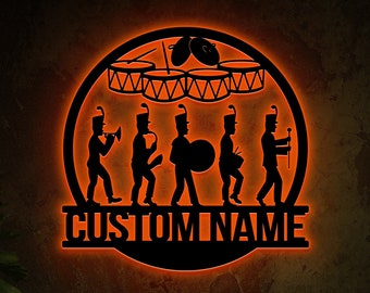 May include: A black metal silhouette of a marching band with drums and the text "CUSTOM NAME" in a circle with an orange glow.
